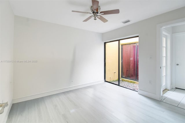 unfurnished bedroom with access to exterior, wood finished floors, visible vents, and baseboards