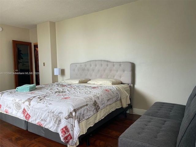 bedroom with dark hardwood / wood-style floors