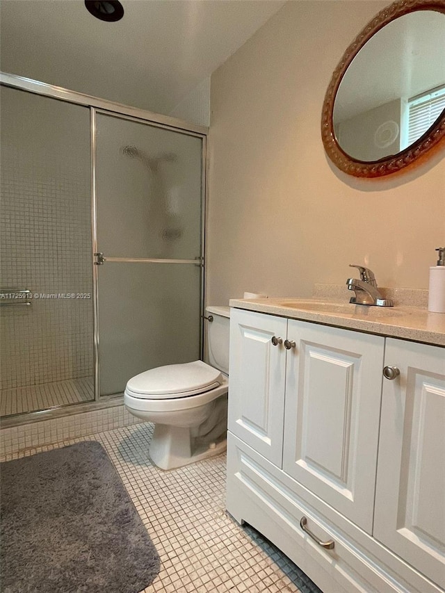 bathroom featuring vanity, an enclosed shower, tile patterned flooring, and toilet