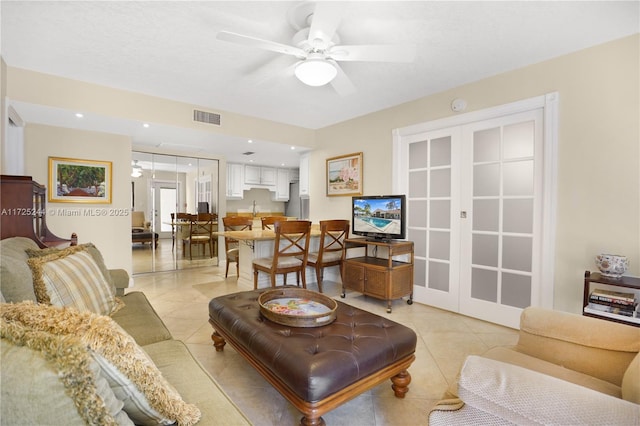 living room featuring french doors, ceiling fan, and light tile patterned floors