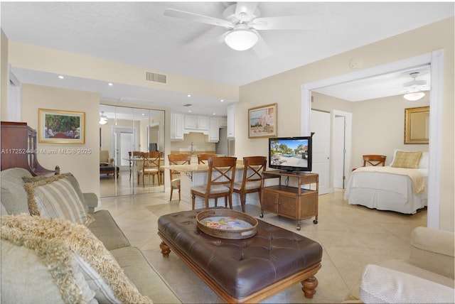 tiled living room featuring ceiling fan