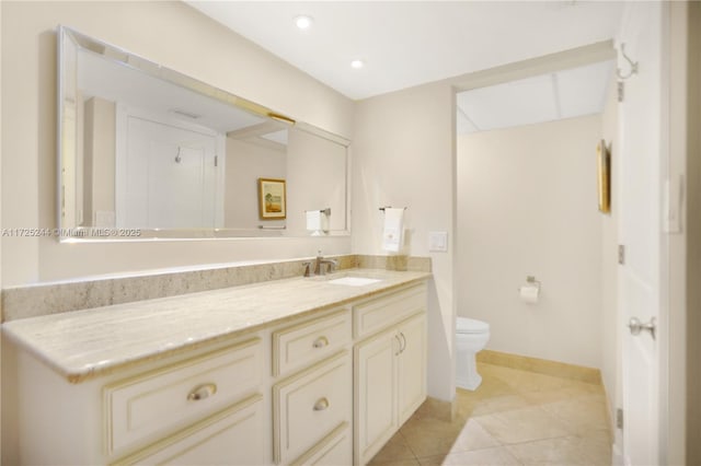 bathroom featuring tile patterned floors, vanity, and toilet