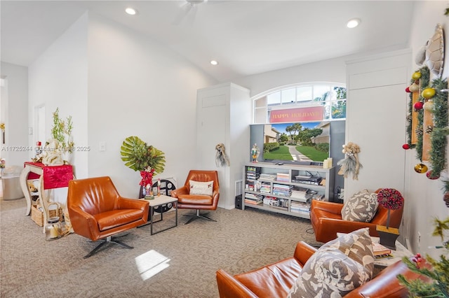 living room featuring lofted ceiling, carpet flooring, and ceiling fan