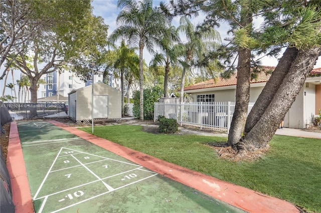 view of home's community with a yard and a storage shed