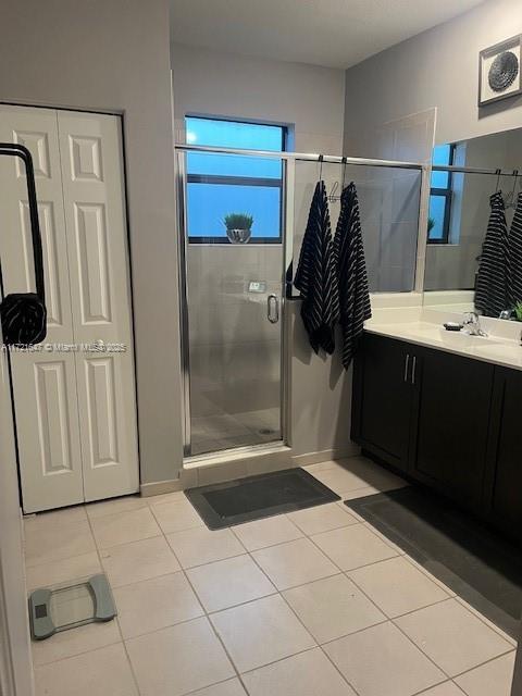 bathroom featuring an enclosed shower, tile patterned floors, and vanity