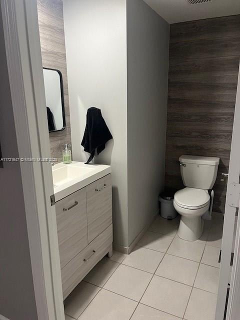 bathroom featuring toilet, vanity, and tile patterned flooring