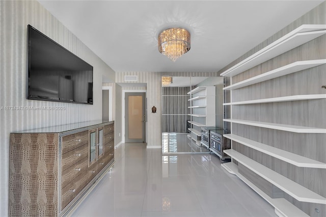 interior space with light tile patterned floors and a notable chandelier