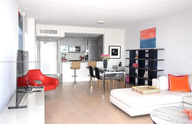 living room with light hardwood / wood-style flooring