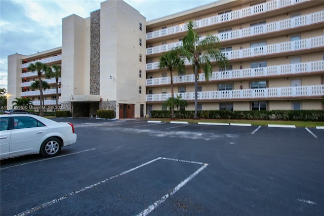 view of property featuring uncovered parking