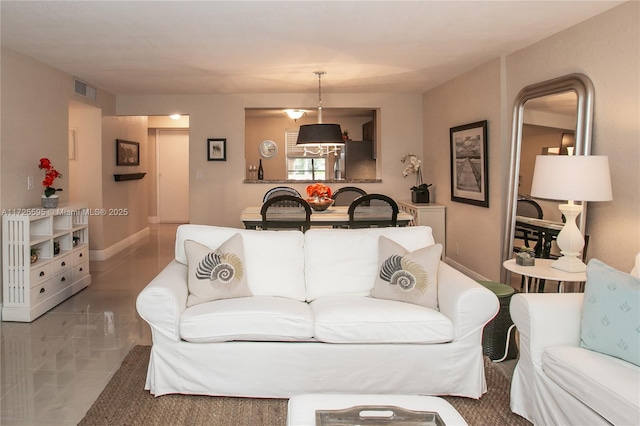 living area with visible vents and baseboards