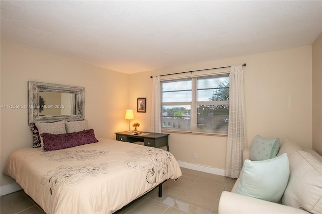 bedroom with tile patterned flooring and baseboards