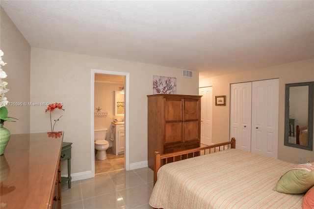 bedroom featuring visible vents, connected bathroom, baseboards, and light tile patterned floors