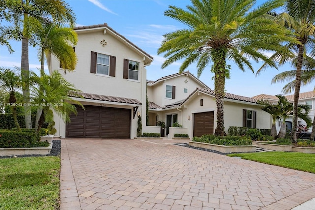 mediterranean / spanish home featuring a garage