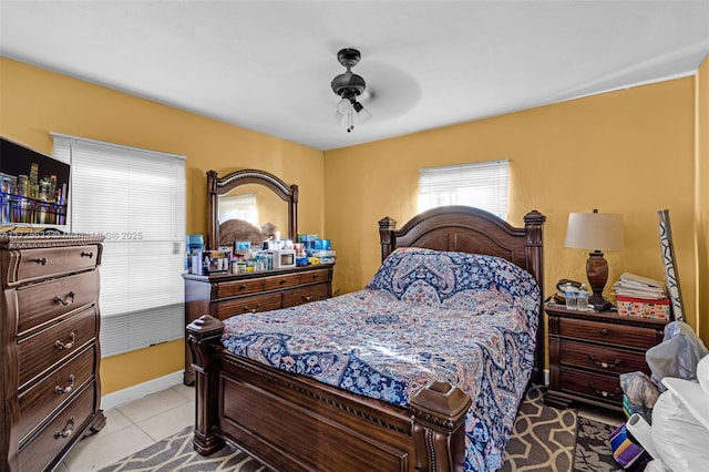 bedroom with ceiling fan and light tile patterned floors