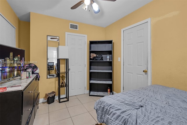 bedroom with ceiling fan and light tile patterned flooring