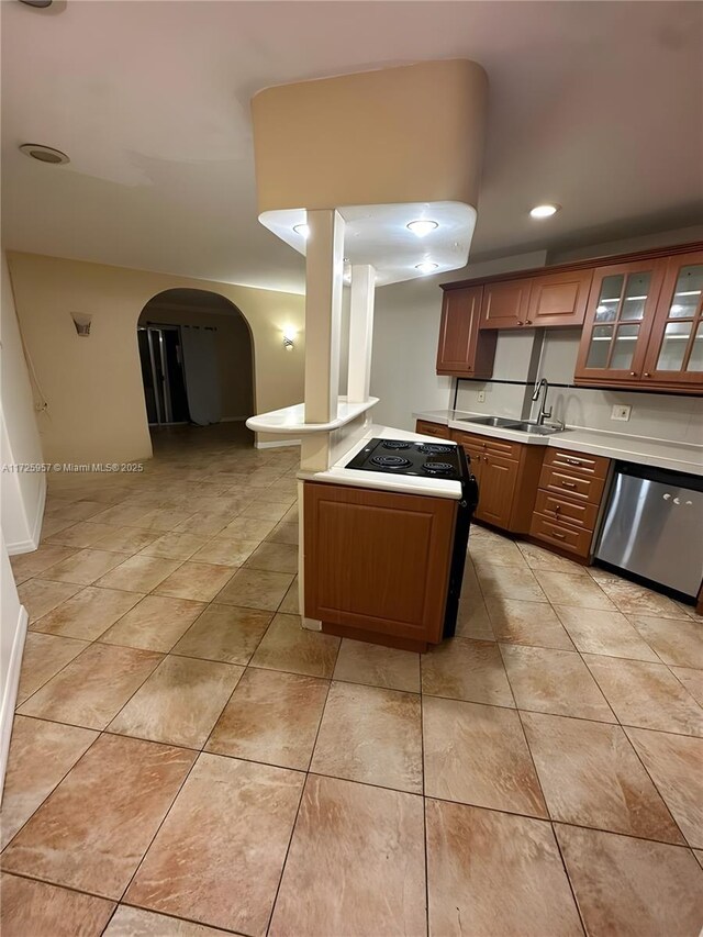 kitchen with appliances with stainless steel finishes, sink, and light tile patterned floors