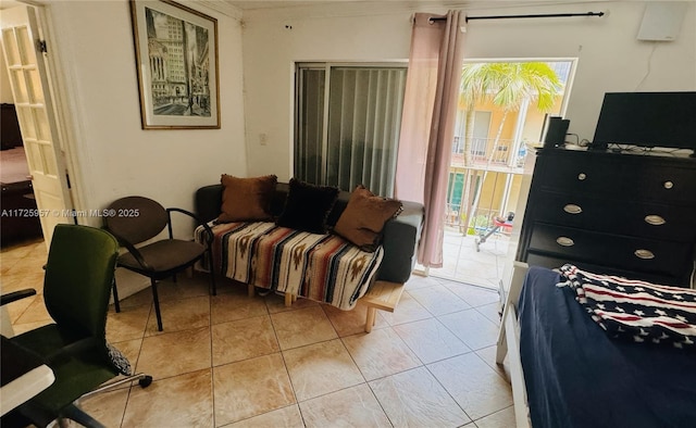 bedroom with access to outside and light tile patterned floors