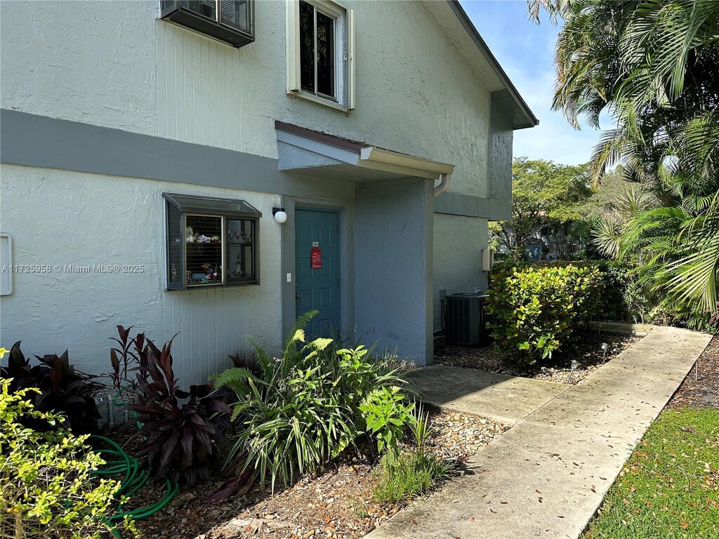 doorway to property featuring central air condition unit