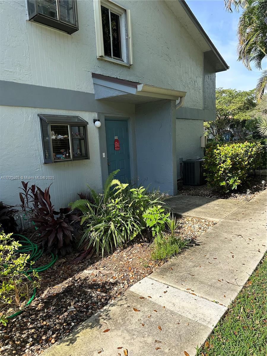 entrance to property featuring central AC