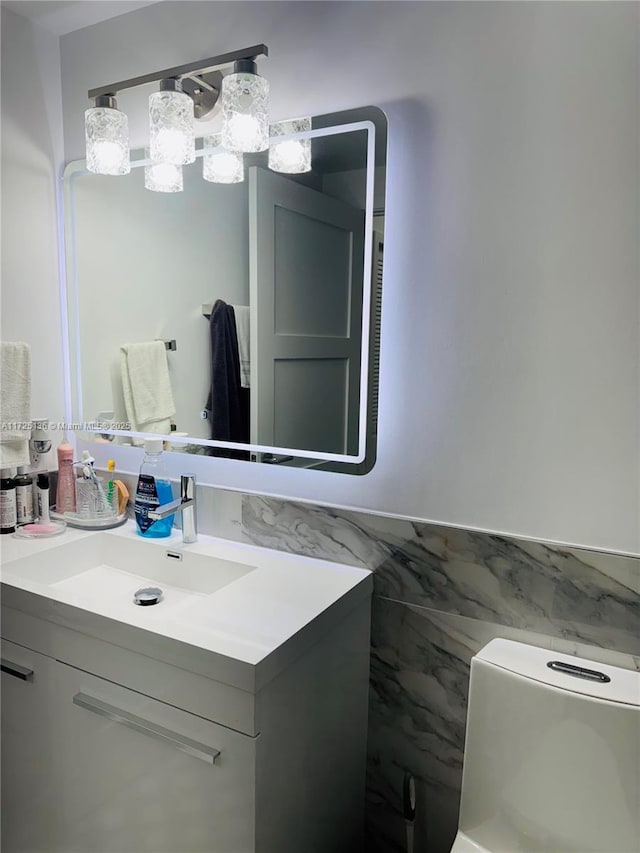 bathroom featuring vanity and tile walls