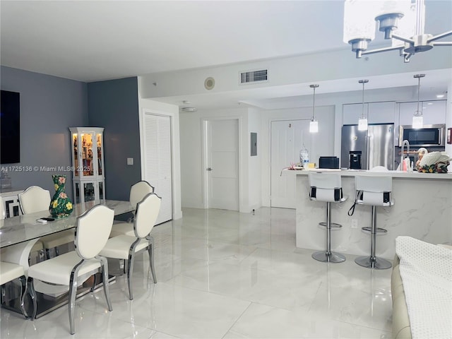 dining space featuring a notable chandelier