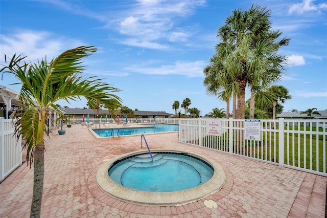 view of swimming pool with a community hot tub