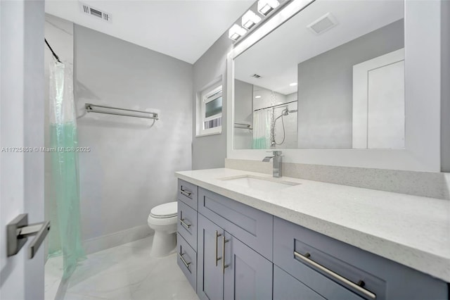 bathroom with curtained shower, vanity, and toilet