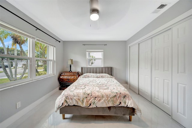 bedroom with ceiling fan and a closet