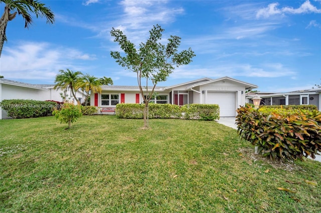 ranch-style house featuring a front yard and a garage