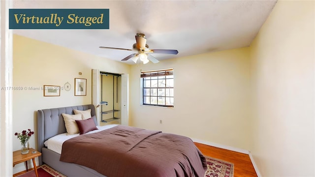 bedroom with hardwood / wood-style flooring and ceiling fan