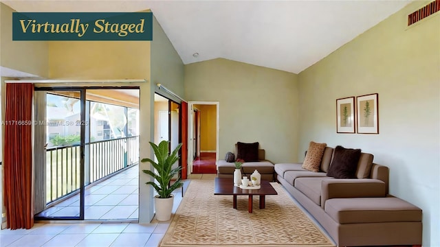 living room with lofted ceiling and light tile patterned floors