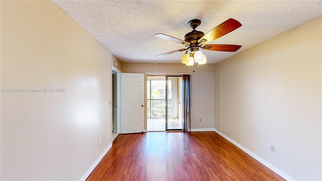 spare room with ceiling fan, hardwood / wood-style floors, and a textured ceiling