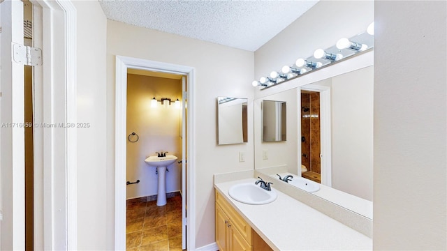 bathroom with sink and a textured ceiling