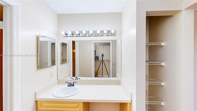 bathroom with vanity and a textured ceiling