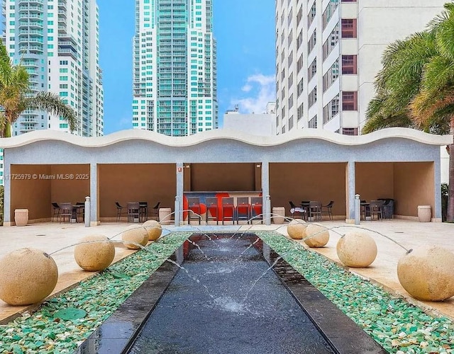 view of home's community with an outdoor bar and a patio