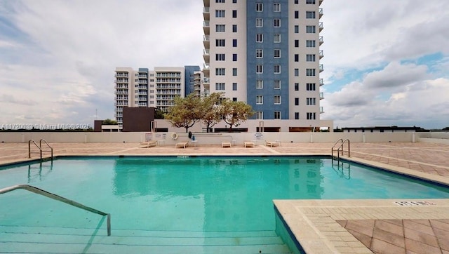 view of pool featuring a patio