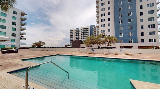 view of swimming pool with a patio