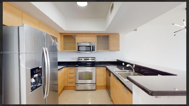 kitchen featuring appliances with stainless steel finishes, light tile patterned floors, sink, and light brown cabinets