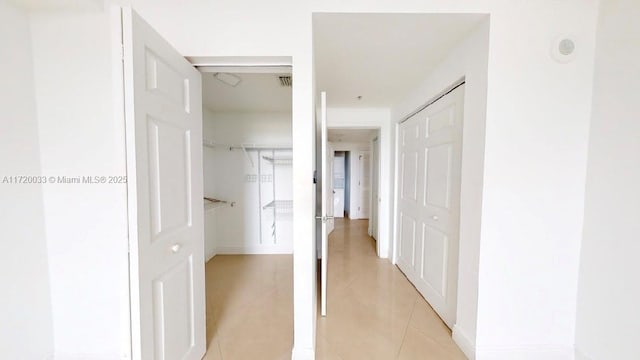 corridor featuring light tile patterned floors