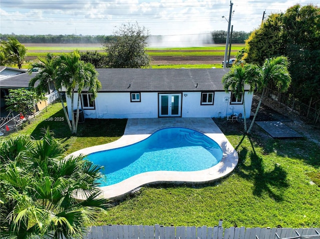 view of swimming pool with a patio and a lawn