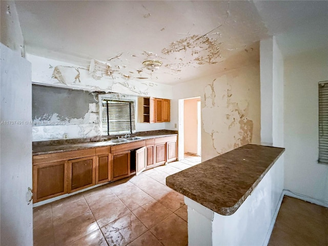 kitchen featuring light tile patterned flooring and sink