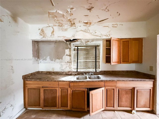 kitchen featuring sink and light tile patterned flooring