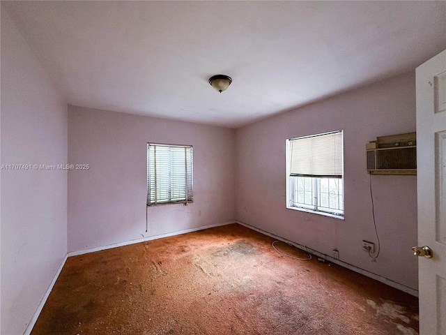 unfurnished room with an AC wall unit