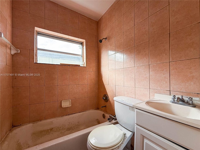 full bathroom featuring toilet, vanity, tile walls, tasteful backsplash, and tiled shower / bath combo