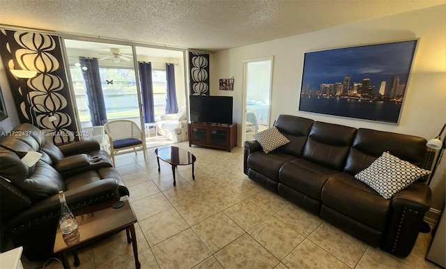 tiled living room featuring a textured ceiling and ceiling fan