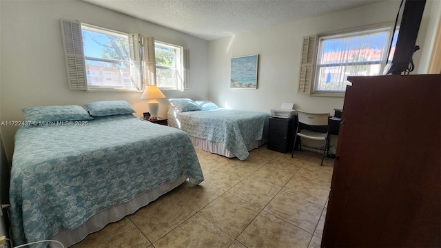 tiled bedroom with a textured ceiling