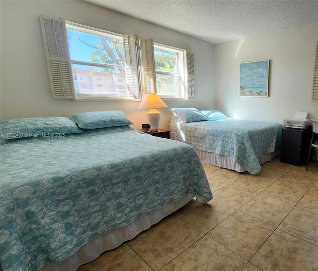 tiled bedroom with a textured ceiling