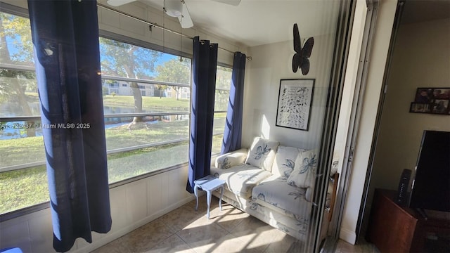 interior space featuring ceiling fan and a wealth of natural light