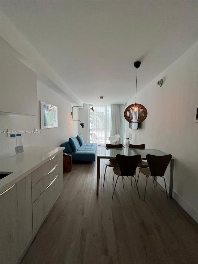 dining space featuring wood-type flooring