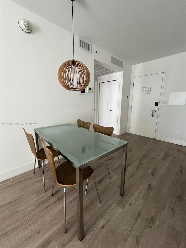 dining space with hardwood / wood-style flooring